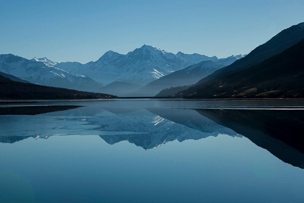 image of mountains with a lake showing reflection in front
